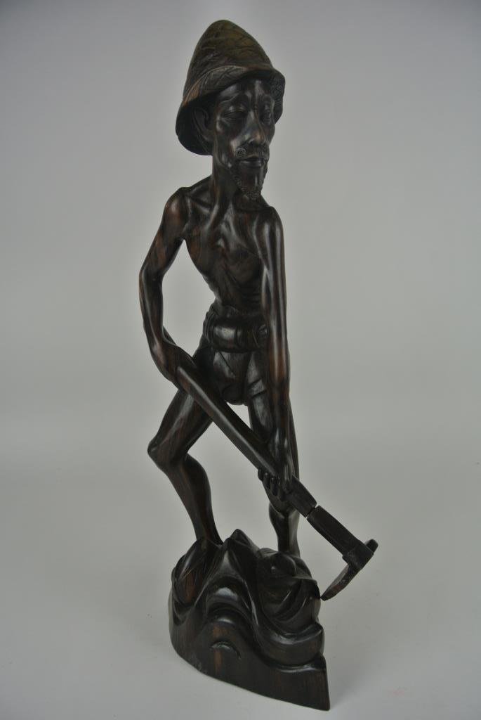 J78-4 EBONY WOOD CARVED FARMER: Measures 19 3/4" tall. Estimate $100- 200. Starting Bid $10.