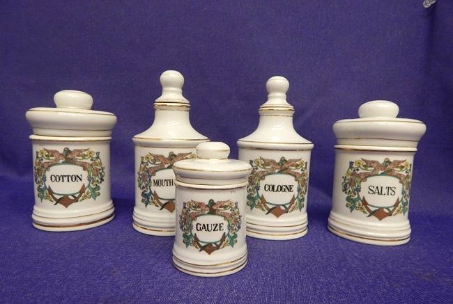 A30-7 VINTAGE GERMAN APOTHECARY JARS & BOTTLES: Including three covered jars marked "Cotton" and "Salts" 5 1/2", "Gauze" 3 1/2", two bottles with stoppers marked "Cologne" and "Mouthwash" both 6". Great Condition. Estimate $300 - $400 Starting Bid 