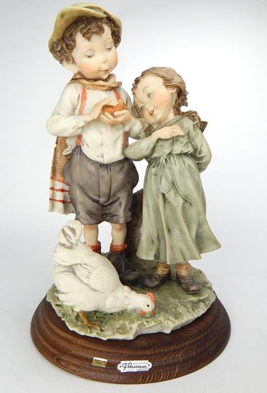 J65-95 CAPODIMONTE FIGURINE BY GIUSEPPE ARMANI: Boy and girl with chicken. Makers mark and signature. Measures 12". Estimate $100 - $200 Starting Bid $20