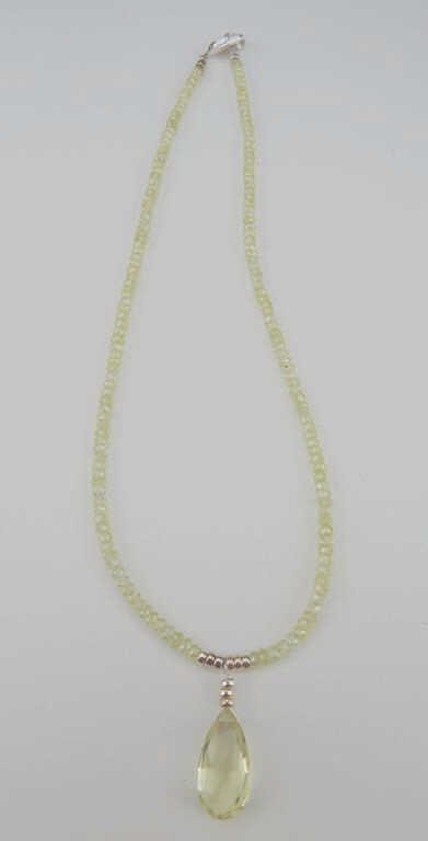 K34-3 LEMON TOPAZ NECKLACE: With sterling silver. Estimate $300 - $400 Starting Bid $10