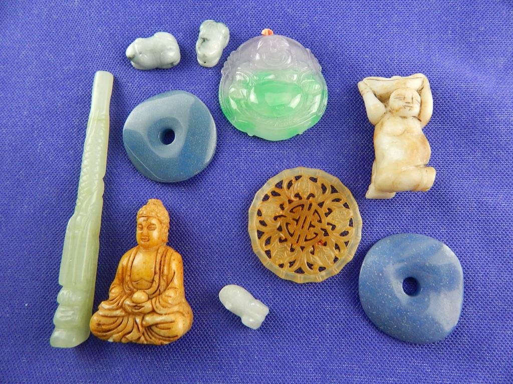 Ten Carved Chinese Items: Two pendants 2" diameter, One buddah 2 3/8", One man 2 1/4", Two rings 1 3/4", One stick 5", Three frogs 1". Estimate $500 - $800. Starting bid $20.