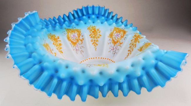 19th Century French Blue Opalescent Hobnail Center Bowl: White to blue opaline hobnail ruffled edge center bowl highly decorated with hand painted flowers and gilt enamel, pinched pie crust edge with waffle pattern, measures 6" x 14 3/4" x 15". Estimate $50