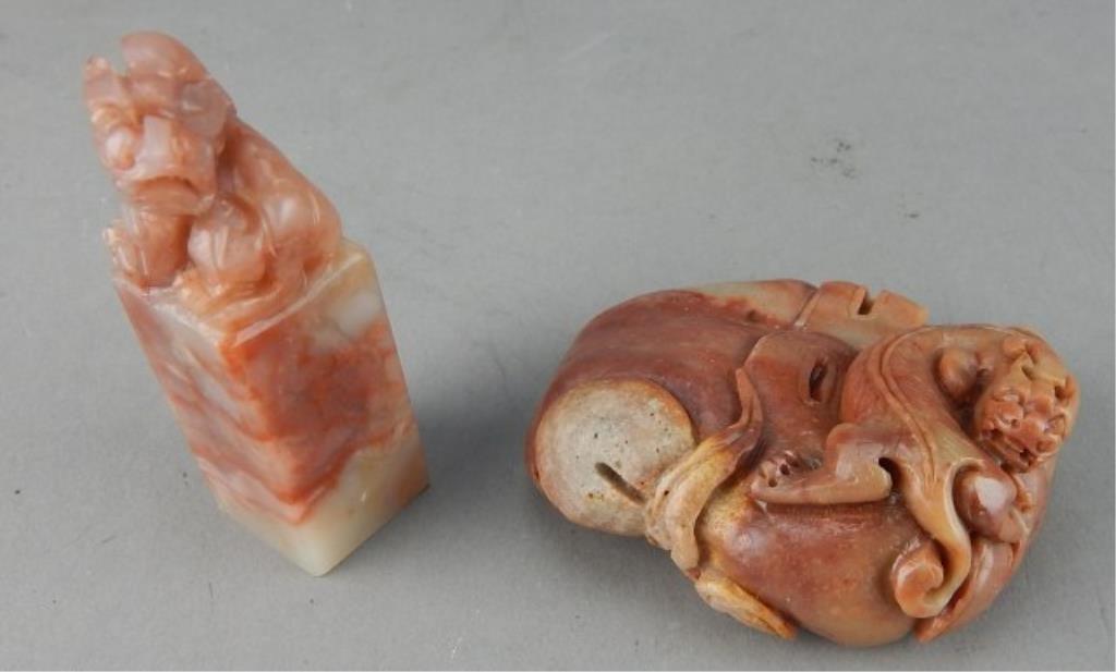Two Red Soapstone Carvings: One is a stamp measures 2 5/8" tall x 7/8" x 7/8", and carving measures 2 1/2" x 2 3/4". Estimate $200 - $300. Starting bid $50.