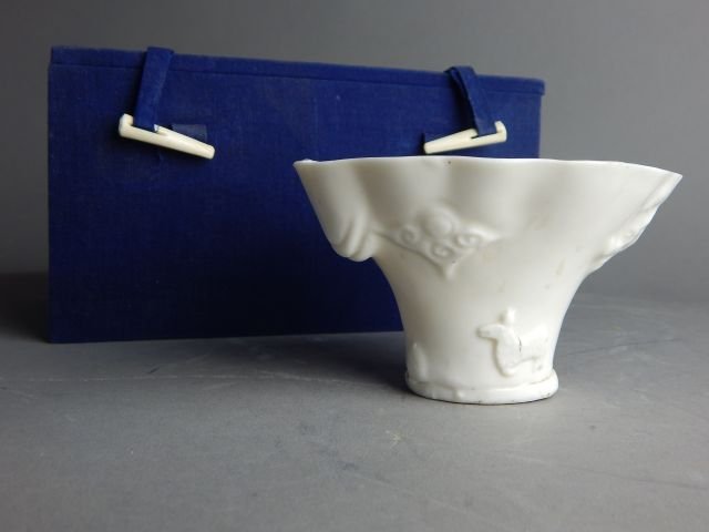Chinese White Porcelain Cup: Comes with fabric box, cup measures 3 1/2" x 4 1/2" x 3 1/2". Estimate $300 - $500 Starting Bid $125