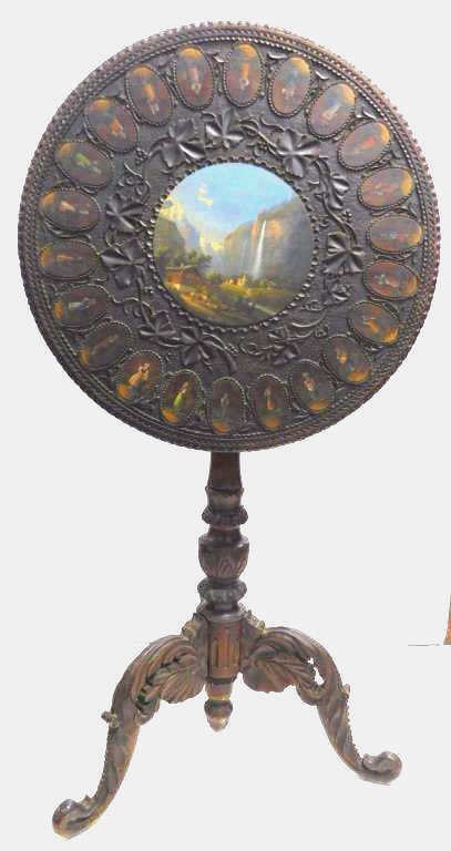 19th Century Carved Black Forest Tilt Top Table: Center wood plaque has oil painting of Staubbach Falls Switzerland at Lauterbrunnen. Early on romantics and nature lovers made a pilgrimage to Staubbach Falls one of the highest free falling waterfall
