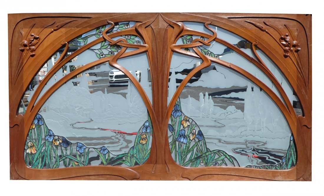 Art Nouveau carved mahogany stained glass transom: Art Nouveau hand carved mahogany transom window with stained, leaded & etched glass with irises, after Eugene Gaillard.Provenance Rod Stewart home in Los Angeles, CA. 46 3/4"h x 84"w