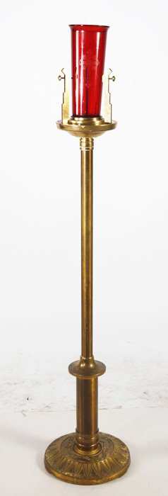Brass Church Pillar Candle Holder: Single pillar church altar candle holder in brass with leaf detail on base and swivel support with red glass shade. 55.5"H x 11"W