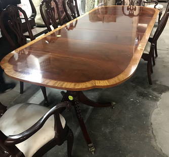 Baker Double Pedestal Dining Table: Mahogany dining table with walnut edges and double pedestal supports with paw feet and wheels. Comes with three leaves. 30"H x 119.5"L x 46.25"W with all leaves.