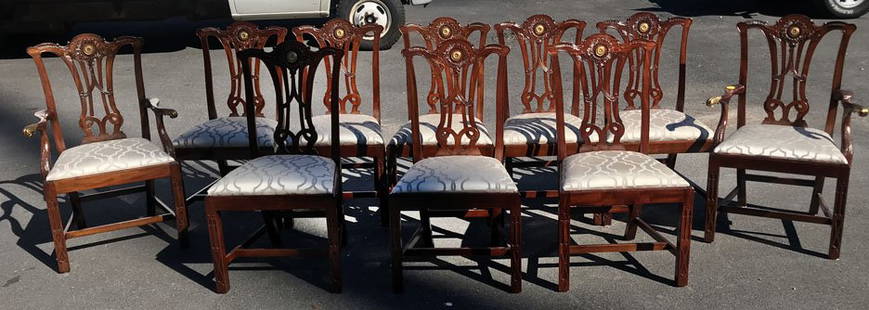 Set of 10 Baker Dining Chairs: Set of 10 Chippendale style Baker dining chairs with nicely carved top rails, gold cabochons, and cream upholstery. 2 armchairs: 40"H x 26"W x 20.5"D. 8 armless chairs: 39.5"H x 21"W x 20"D