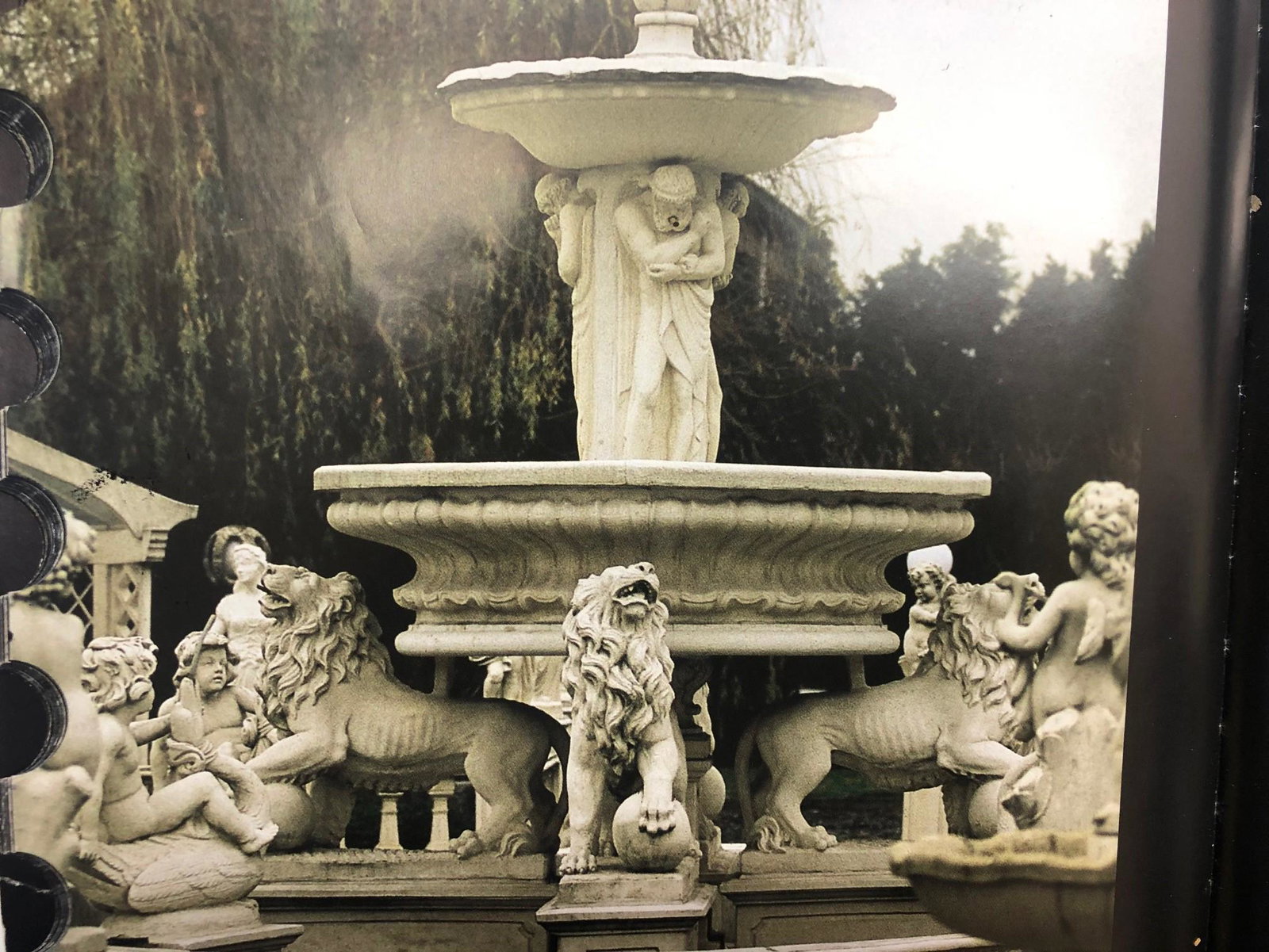 Large figural fountain with 4 large lions at the base,: Large figural fountain in cast stone with 4 lions at the base and atlas' supporting the upper bowl. Babies riding swans frolick in the pool and the coping has palm leaf detail and has a large cap that