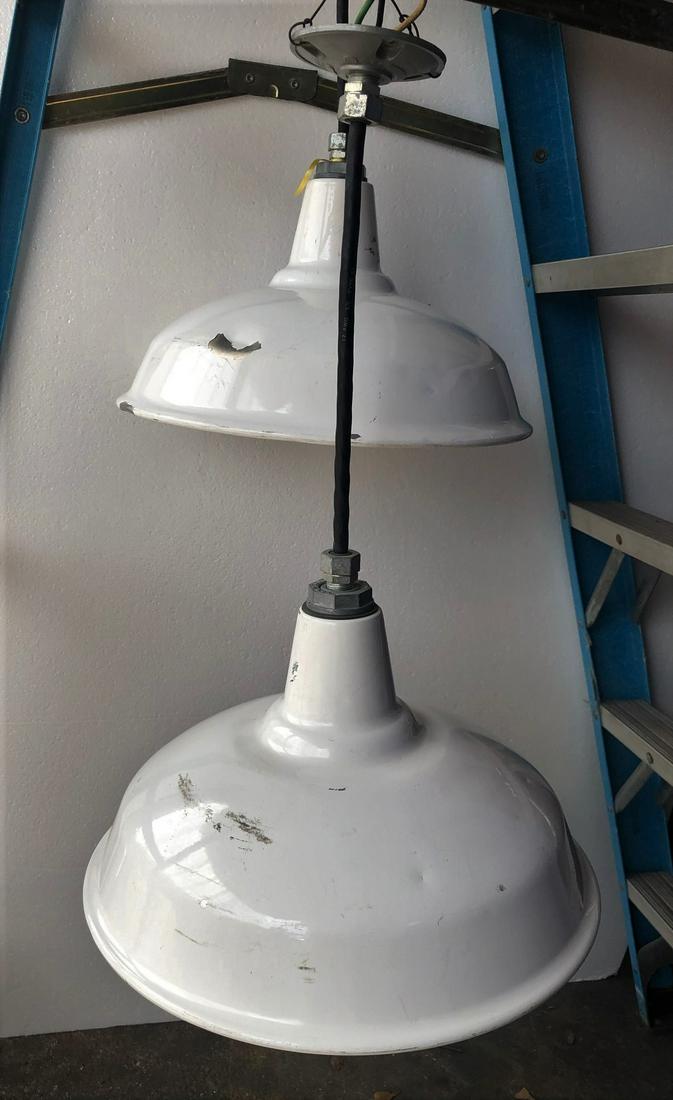 2 white industrial warehouse lights: 2 white industrial warehouse lights. 16" diameter 25" drop.