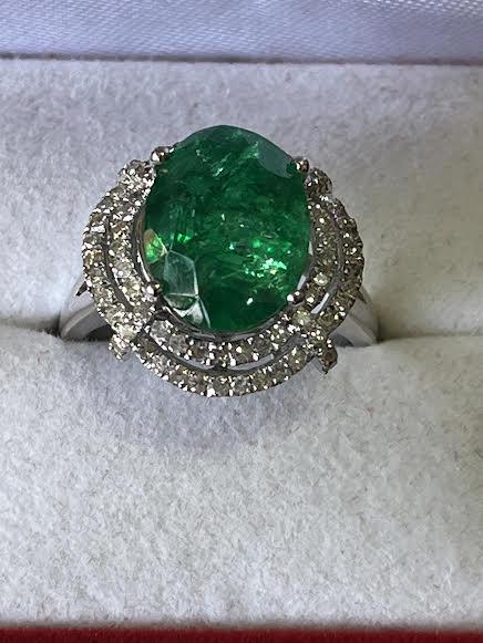 Oval Cut Emerald Cocktail Ring with 2 halo rows of diamonds, set in 14K white gold.: Oval Cut Emerald Cocktail Ring with 2 halo rows of diamonds, set in 14K white gold.