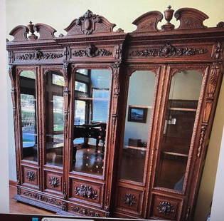 French Carved Oak 5 Door Bookcase: Carved French oak bookcase with attributes of the arts carved around the glass on the doors. 94"H x 110"ZW x 19"D.
