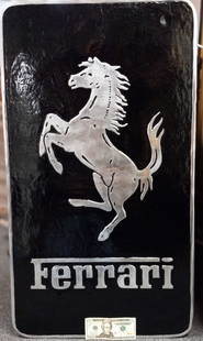 Ferrari Building Advertisement: Silver and black heavy cast aluminum building display advertising "Ferrari" back side hanging hooks set within the display. 32"h x 20"w