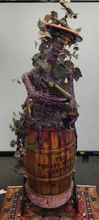 The Grape Goblin: A life sized figure holding grapes standing in a wine barrel for display art for a wine tasting or almost any party. Originally made as a promotional piece. 8ft. X 22"w x 28"d.