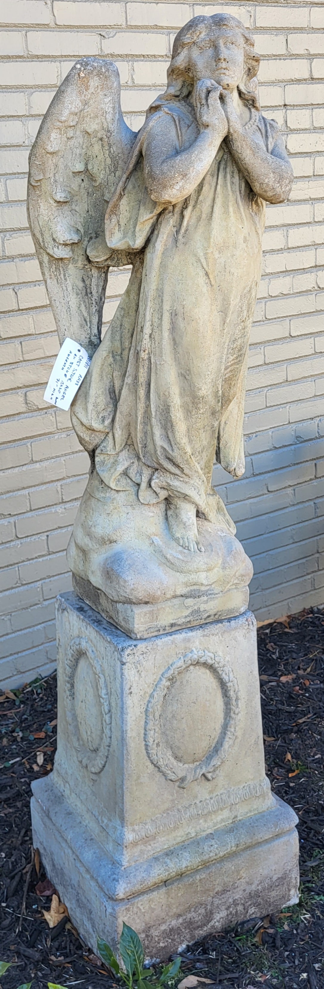 Winged Angel on a Pedestal in Cast Stone: Cast stone angel with praying hands on a pedestal. 71" High