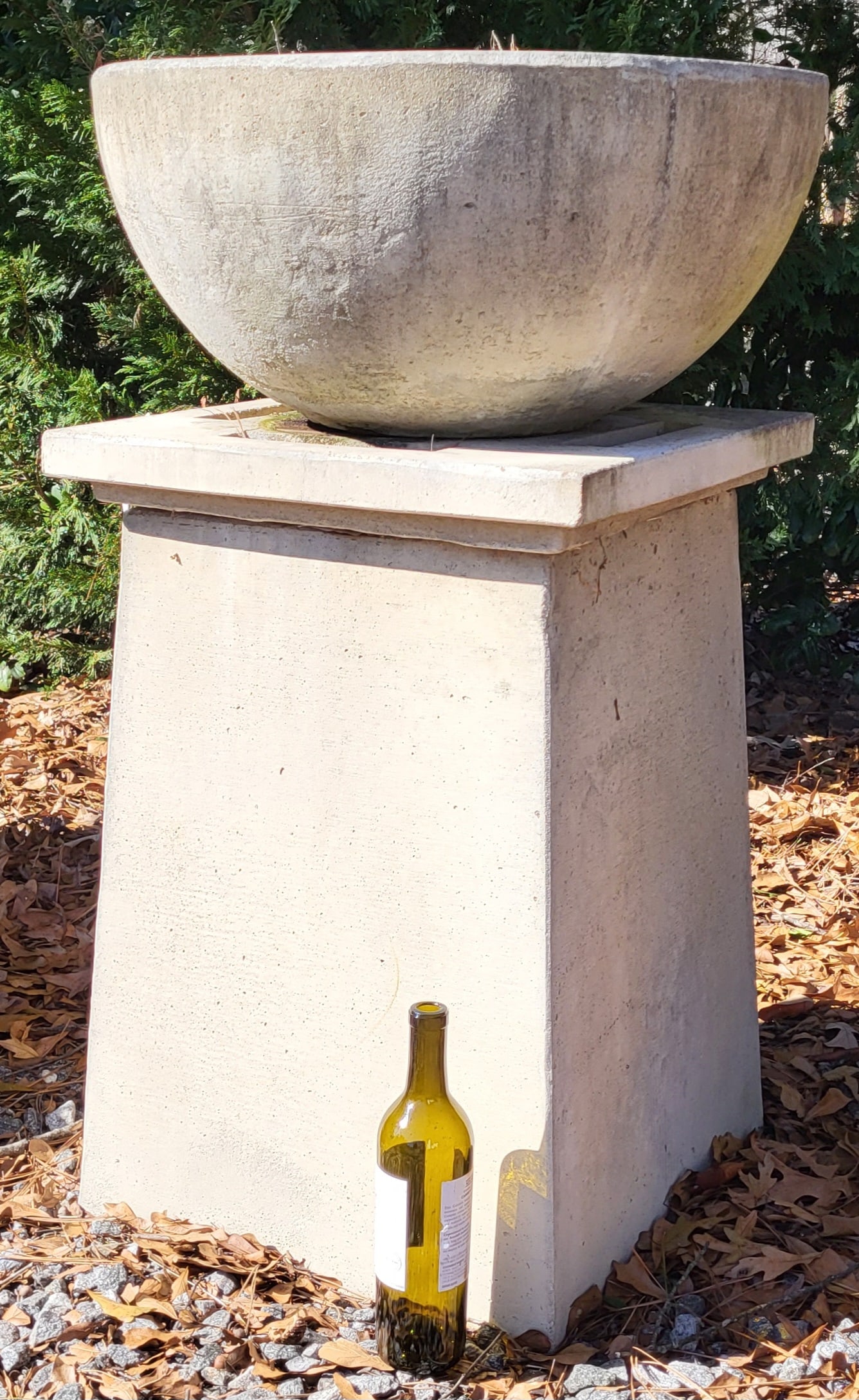Modern Style Urn And Base: Add a modern touch to your outdoor space with this set. Each urn is a rounded bowl that sits on top of a cleaned lined base made of belgium stone and stands 40'h x 24"w .