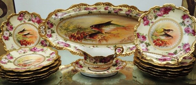 Antique Imperial Limoges Plate 15 pc Service Set: Antique Imperial Limoges 19 pc service depicting game fish with rose detail. Lot includes: 12 dinner plates, 1 serving tray, and a gravy boat with resting plate.