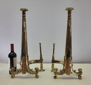Brass Andirons with Bronze Overlay: Pair of andirons in brass with bronze overlay. Early 20th century. 24"H x 11 wide at base.