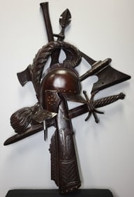 Carved Wall Crest with Attributes of Battle: Detailed carved wall crest with attributes of battle to include a helmet and rifle 34"h x 22"w