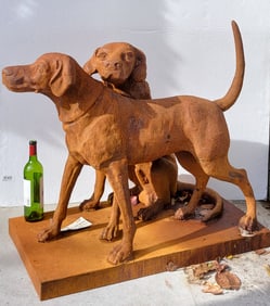 A Cast Iron Sculpture Of Two Dogs