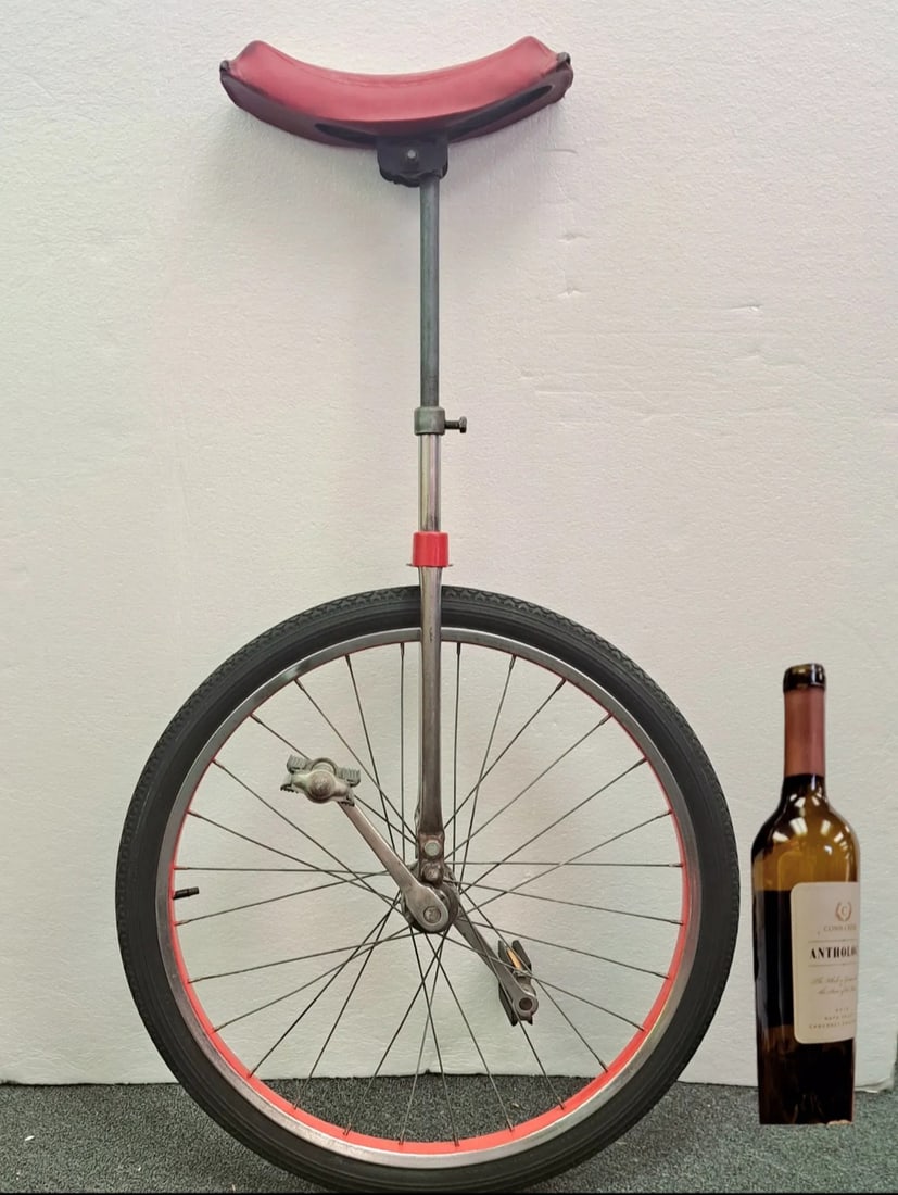 Circus Unicycle 1950"s With Red & White Leather Seat: Circus unicycle with polished silver base and a red with white stripe seat 48" H with a 20"Wheel