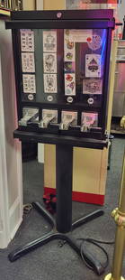 Sticker Vending Machine: Sticker vending machine on single pedestal base. 52"H x 21"W x 14"D