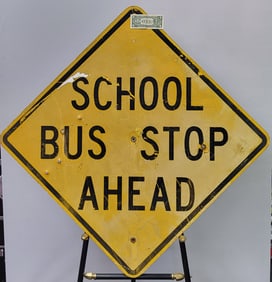 School Bus Stop Ahead official traffic sign with minot time deterioration. 36" H x 36" W