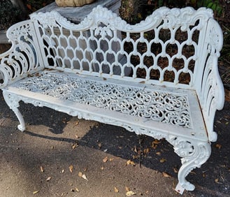 Cast iron garden bench with curved back and open iron work in white. 37" H x 62" W x 20" D