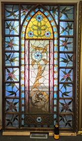 Monumental 3rd street stained glass with traditional blues and orange jewels floral center window.