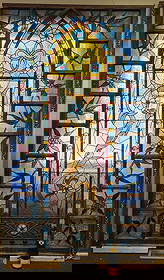 Monumental 3rd street stained glass with traditional blues and orange jewels floral center window.: Monumental 3rd street stained glass with traditional blues and orange jewels floral center window. 8ft h x 4.5ft w