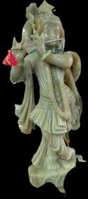 Jade statue of Hindu god Krishna playing the flute.  63"H x 38"W x 12"D
