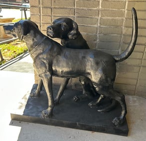 Cast iron statue of two hunting dogs sitting together. 30" H x 20" W x 36" D