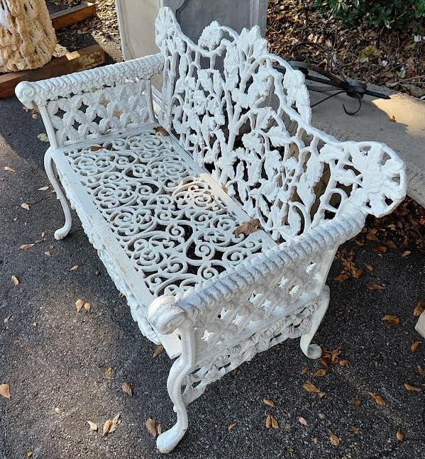 Cast iron garden bench with floral design and rams heads on the arm rests. 37" H x 43" W 34" D (1 of 3)