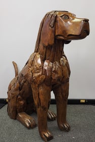 Handcrafted teak wood pieces put together to create a life size sculpture of a sitting dog. 42" H x