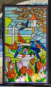 Stained glass window featuring birds in a bird bath.   35"H x 21"W