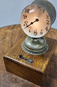 Antique German made traveling bedside clock with a magnifying convex glass face and whimsical