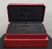 Classic high end jewelry Cartier watch case on their typical red and gold decor.