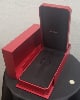 Classic high end jewelry Cartier watch case on their typical red and gold decor.