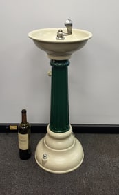 Antique restored pedestal drinking fountain on a flute column base, dark gloss green, heavy irion.