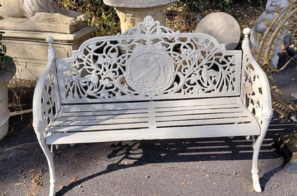 Cast iron garden bench with a floral design with birds and a medallion.  38"H x 52"W x 19"D