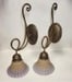 Wall sconces a pair of French vintage single arm bronze wall sconces with frosted glass shades.