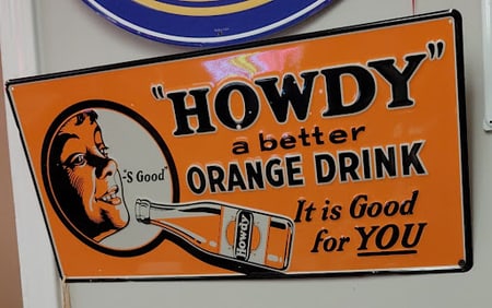 "Howdy" A better Orange Drink sign, tin with the classic orange background silhouette of a boy