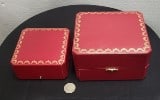 Two Cartier Jewelry Cases, red with gold decor.