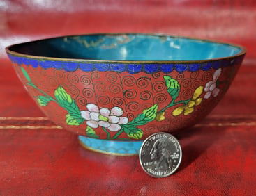 Chinese Cloisonne bowl in orange and blue with floral garlands. 2.5" H x 6" D
