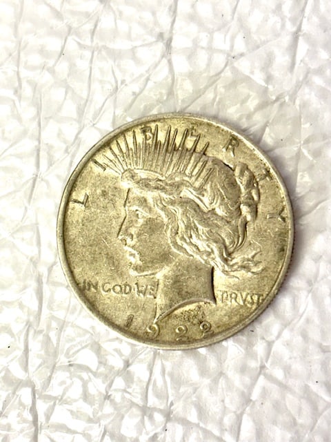 1922 D United States Peace Silver Dollar | Denver Mint | Vintage US Coin: 1922 D Peace Silver Dollar struck at the Denver Mint containing 0.7734 troy ounces of pure silver. This 90% silver dollar features Anthony de Francisci’s iconic Lady Liberty design.Issuer: