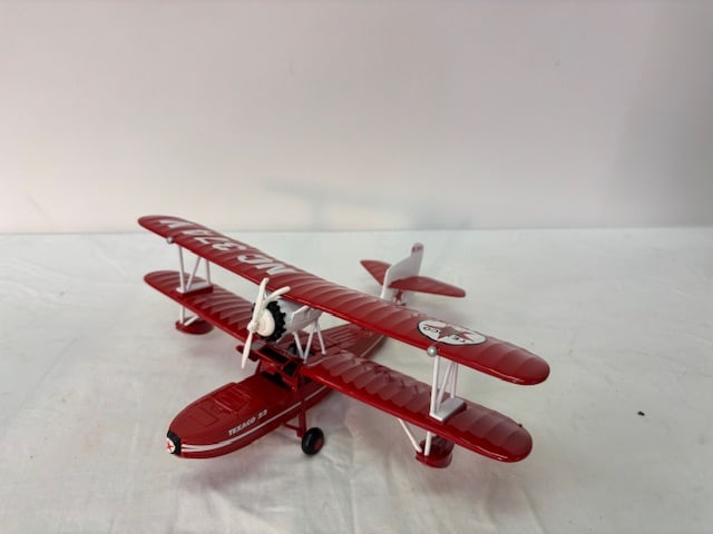 Pair of Branded Die Cast Model Biplanes – Smith & Wesson & Texaco.: Two collectible diecast model biplanes: Smith & Wesson promotional plane and bright red Texaco biplane (NC 374V) both in original boxes that each measure approx. 12" x 9" x 5".