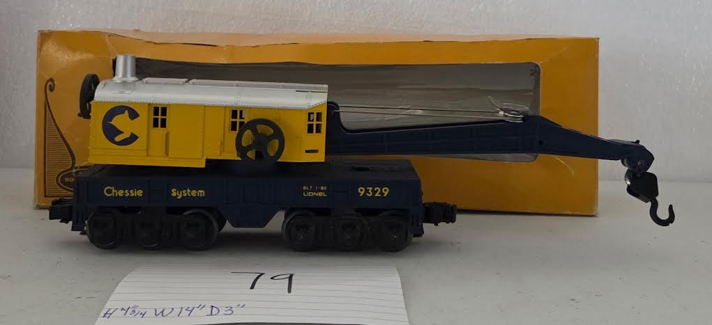 Lionel Chessie System Crane Car 9329 Boxed: Lionel Chessie System crane car No. 9329 with original box. Yellow and blue crane car with operating hook arm and Chessie System markings. Approx. 4.75" H x 14" W x 3" D per card. Box shows storage