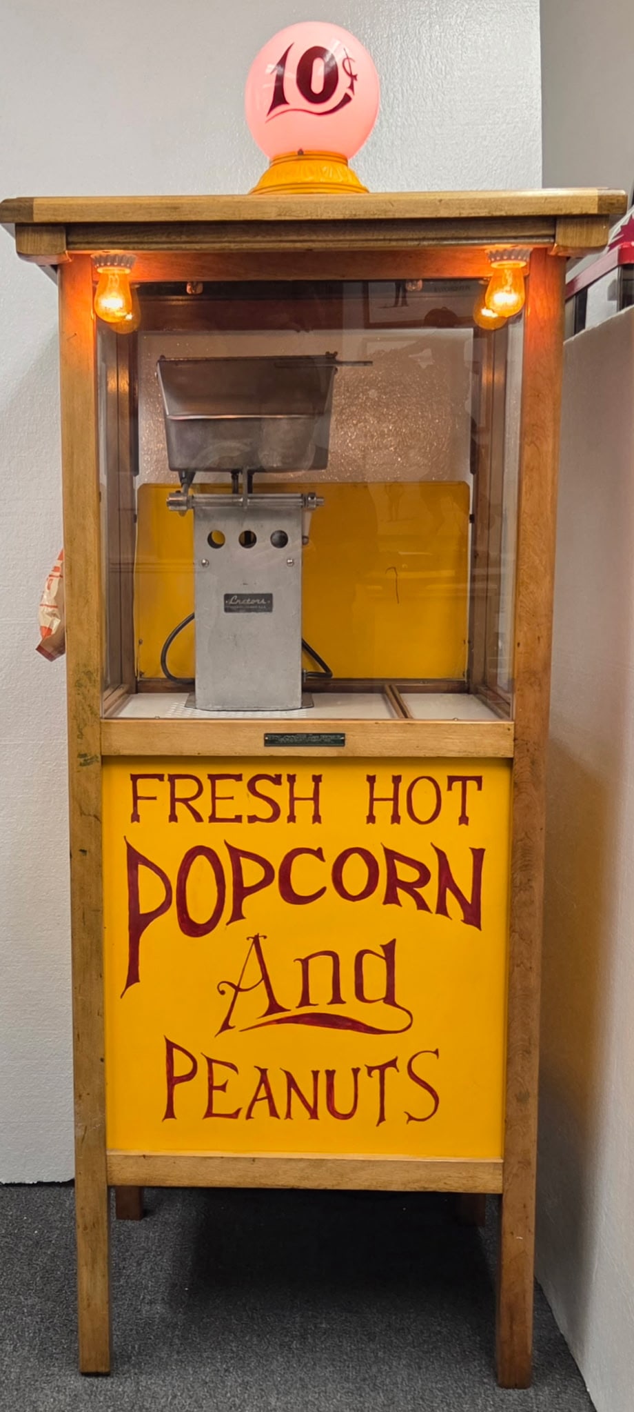 Holcomb & Hoke Popcorn & Peanut Vendor with Cretors Interior: Vintage working popcorn and peanut vendor cabinet featuring a front Holcomb & Hoke plaque and interior C. Cretors & Co. popcorn/roasting equipment. The cabinet has a glass display front, painted yello