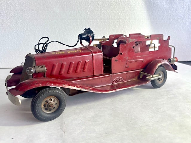 Marx Pre-War Pressed Steel Fire Department Wind-Up Truck: Pre-war (1939–1941) Marx pressed-steel Fire Department truck. Red body with yellow “FIRE DEPT.” lettering on the cab, functional wind-up motor mechanism as visible in the underside p